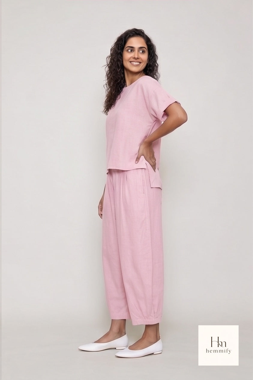 Woman wearing a pink outfit with a plain background
