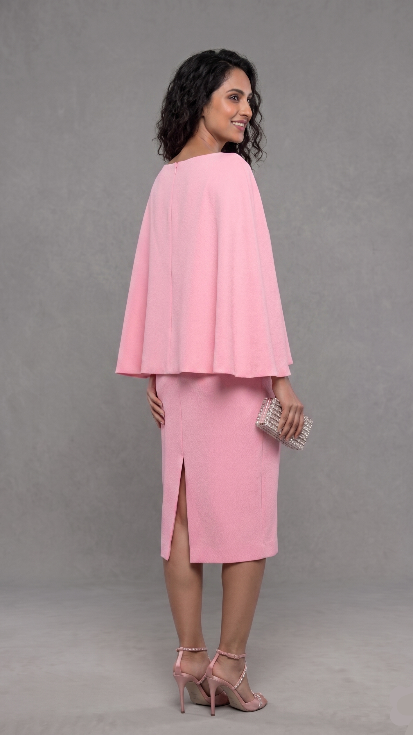 Woman wearing a pink cape and skirt set