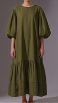 Woman wearing a green dress with puffed sleeves 