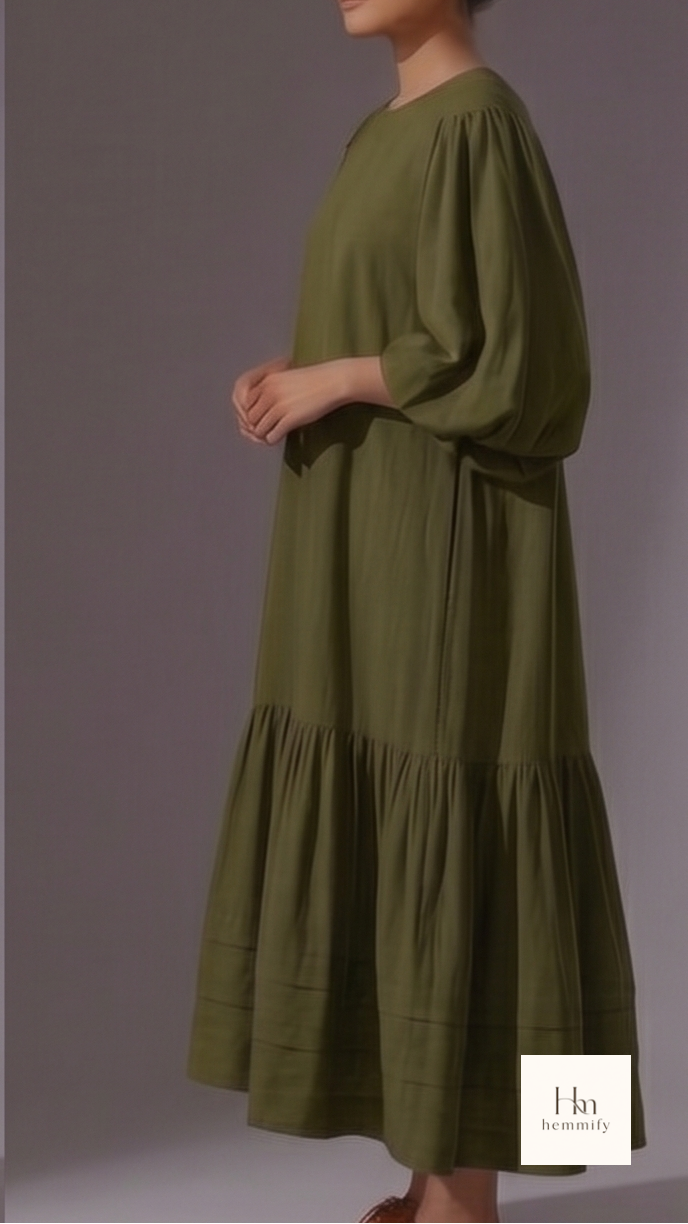 Woman wearing a green dress with a plain background
