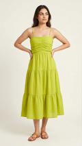 Woman wearing a green dress against a plain background