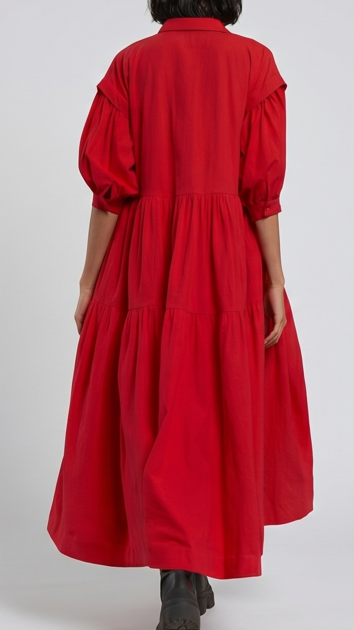 Person wearing a red dress with long sleeves on a white background