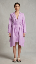 Woman wearing a light purple trench coat against a plain background