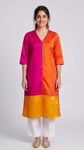 Woman wearing a two-tone pink and orange kurta with white pants on a light gray background