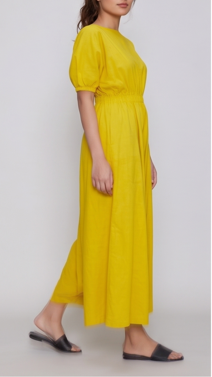 Woman wearing a yellow dress against a background