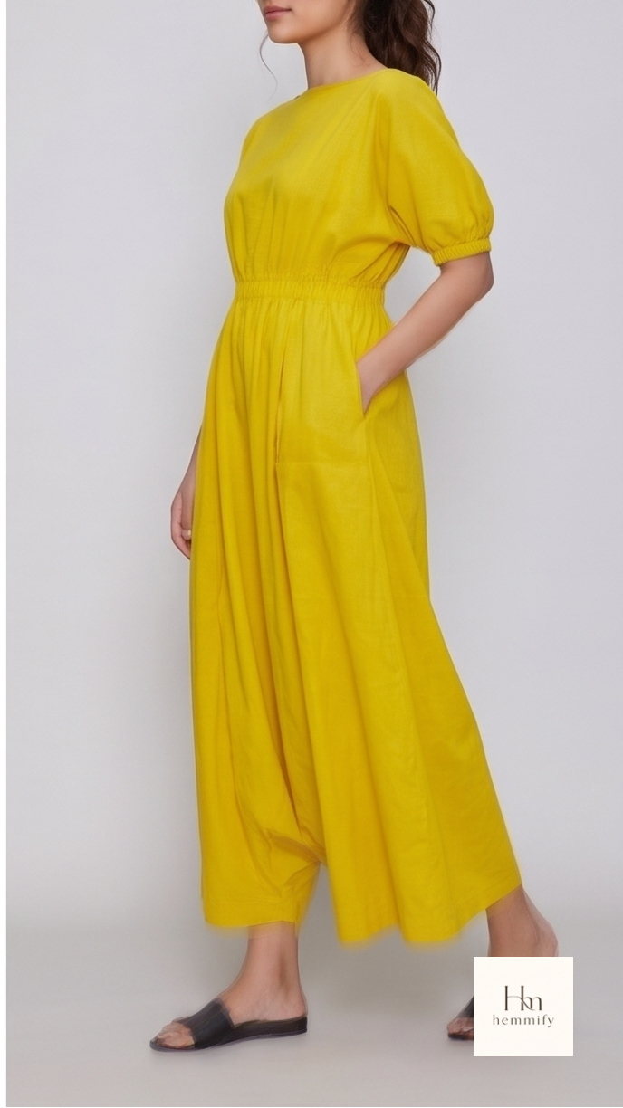 Woman wearing a yellow dress against a background