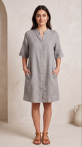 Woman wearing a gray dress with a neutral background