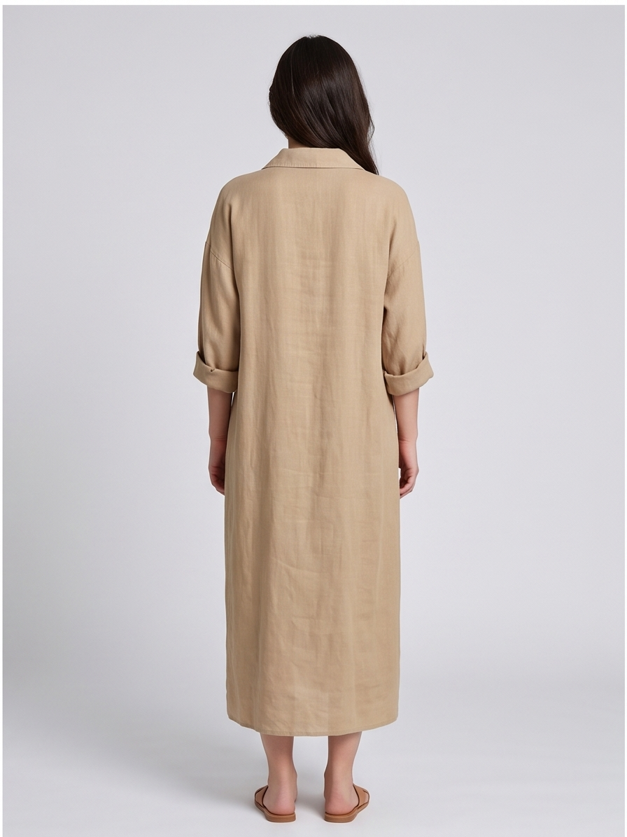 Woman wearing a beige long coat on a plain background