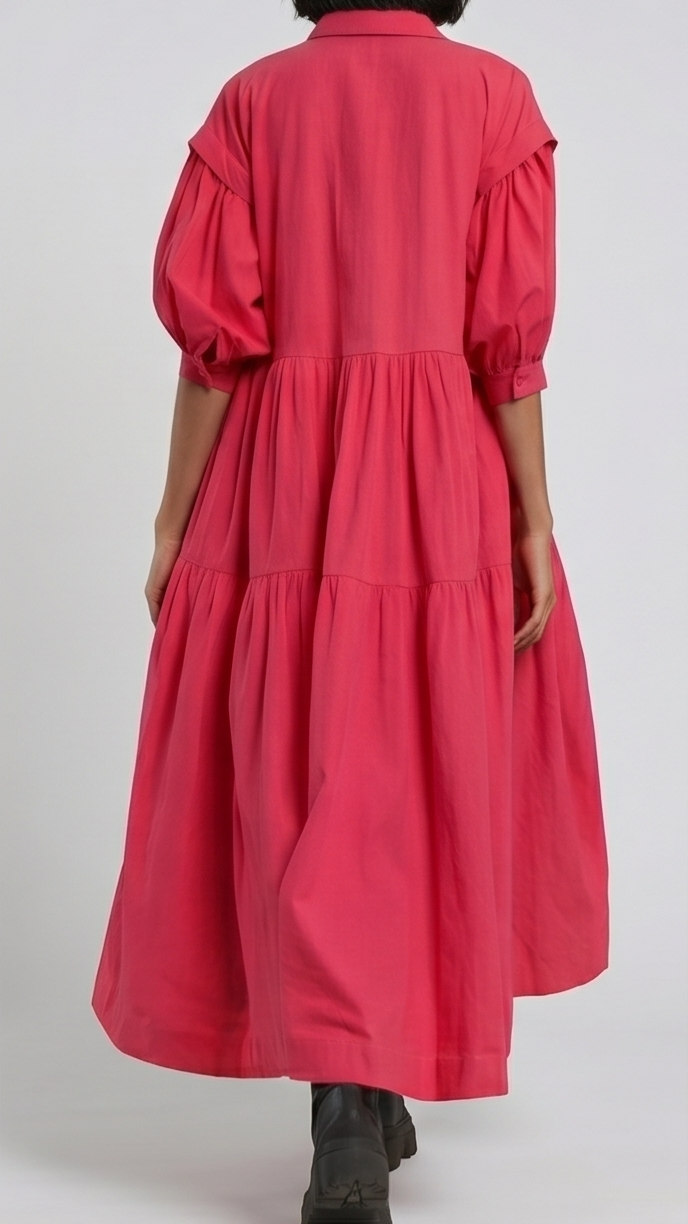 Person wearing a red dress with puffed sleeves on a white background