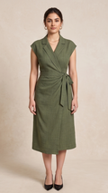 Woman wearing a green dress against a beige background