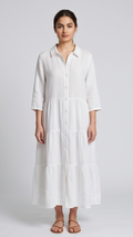 Woman wearing a white dress against a plain background